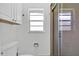 Bright bathroom features white cabinets, natural light from window, and a walk-in shower at 969 Gran Paseo Dr, Orlando, FL 32825
