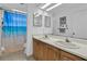 Bathroom features double sinks, a large mirror, and a shower with a beach themed curtain at 969 Gran Paseo Dr, Orlando, FL 32825