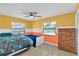 Bright bedroom boasts colorful accent walls, windows with blinds, and dresser at 969 Gran Paseo Dr, Orlando, FL 32825