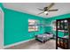 Vibrant bedroom with bunk beds, modern ceiling fan, and a view to the backyard at 969 Gran Paseo Dr, Orlando, FL 32825