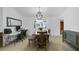 Dining room with chandelier, bench seating, and modern decor with a window view at 969 Gran Paseo Dr, Orlando, FL 32825