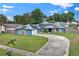 Charming home with a well-manicured lawn, stone accents, and a circular driveway at 969 Gran Paseo Dr, Orlando, FL 32825