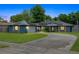 Charming home at twilight featuring an attached garage, solar panels and beautiful landscaping at 969 Gran Paseo Dr, Orlando, FL 32825
