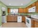 Well-lit kitchen with wood cabinets, granite countertops, and modern white appliances at 969 Gran Paseo Dr, Orlando, FL 32825