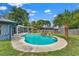 Beautiful kidney-shaped pool with waterfall feature, surrounded by lush landscaping in a fenced backyard at 969 Gran Paseo Dr, Orlando, FL 32825