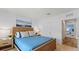 Comfortable bedroom showcasing a cozy bed and access to other areas of the home at 1036 Morfontaine St, Daytona Beach, FL 32124