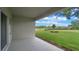 Covered patio overlooking a spacious backyard and lush greenery, perfect for outdoor relaxation and entertainment at 1036 Morfontaine St, Daytona Beach, FL 32124