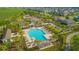 Aerial view of community pool with palm trees, pergolas, and plenty of seating at 10520 Burrows St, Orlando, FL 32832