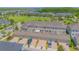 An aerial view shows parking, garages, and lawn space in this planned community with a nearby park at 10520 Burrows St, Orlando, FL 32832