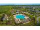 Aerial view of community pool with palm trees, pergolas, and plenty of seating at 10520 Burrows St, Orlando, FL 32832