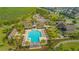 Aerial view of community pool with palm trees, pergolas, and plenty of seating at 10520 Burrows St, Orlando, FL 32832