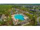 Aerial view of community pool with palm trees, pergolas, and plenty of seating at 10520 Burrows St, Orlando, FL 32832