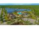 Aerial view of community amenity center featuring pool and lake with fountain; surrounded by lush landscaping at 10520 Burrows St, Orlando, FL 32832