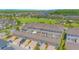 An aerial view of the property shows parking, green space, and a nearby community park at 10520 Burrows St, Orlando, FL 32832