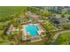 Aerial view of community pool with palm trees, pergolas, and plenty of seating at 10520 Burrows St, Orlando, FL 32832