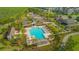 Aerial view of community pool with palm trees, pergolas, and plenty of seating at 10520 Burrows St, Orlando, FL 32832