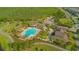 Aerial view of community pool with palm trees, pergolas, and plenty of seating at 10520 Burrows St, Orlando, FL 32832