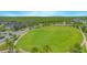 Aerial view showcases a sprawling green lawn, community landscaping, and the neighborhood layout at 10520 Burrows St, Orlando, FL 32832