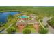 Aerial view of resort-style pool with clubhouse, palm trees, and lake views at 10520 Burrows St, Orlando, FL 32832