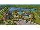 Aerial view of resort-style pool, splash pad, lakeside clubhouse in community at 10520 Burrows St, Orlando, FL 32832