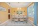 Elegant dining room with a stylish chandelier, dining set for six, and blue accent rug at 10520 Burrows St, Orlando, FL 32832