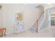 Inviting entryway with staircase, decorative mirror, and stylish console table at 10520 Burrows St, Orlando, FL 32832
