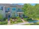 Charming townhome exterior featuring lush landscaping, brick walkways, and well-maintained facade at 10520 Burrows St, Orlando, FL 32832