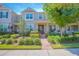 Charming townhouse with well-manicured landscaping, brick walkway, and a welcoming front porch at 10520 Burrows St, Orlando, FL 32832