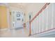 Inviting foyer features tile flooring, staircase, and decorative accents at 10520 Burrows St, Orlando, FL 32832