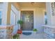 Inviting front entryway with decorative wreath, stone accents, and well potted plants at 10520 Burrows St, Orlando, FL 32832