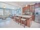 Open-concept kitchen with granite island, pendant lighting, stainless appliances, and adjacent living space at 10520 Burrows St, Orlando, FL 32832