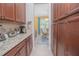 Well-organized kitchen with granite counters, modern appliances, and ample cabinet space at 10520 Burrows St, Orlando, FL 32832