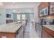 Open concept kitchen with granite countertops and a view into the living room at 10520 Burrows St, Orlando, FL 32832