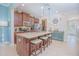 Spacious kitchen with a large granite island, pendant lights, and modern appliances at 10520 Burrows St, Orlando, FL 32832