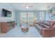 Comfortable living room with wood paneling, plush seating, and ample natural light at 10520 Burrows St, Orlando, FL 32832