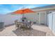 Brick paved patio with outdoor dining set, grill, and white privacy fence, perfect for entertaining at 10520 Burrows St, Orlando, FL 32832