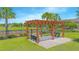 The community pavilion features benches on a concrete slab, surrounded by well-maintained green spaces at 10520 Burrows St, Orlando, FL 32832
