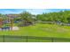 A playground for residents offers benches and playground equipment surrounded by well-manicured green lawn at 10520 Burrows St, Orlando, FL 32832