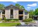 Exterior shot of a two-story condo building with well-maintained landscaping and private balconies at 1074 Kensington Park Ct # 101, Altamonte Springs, FL 32714
