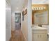 Hallway leading to a bathroom with a shower and wood flooring at 1074 Kensington Park Ct # 101, Altamonte Springs, FL 32714