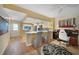 Open-concept living area with a breakfast bar, seamlessly connecting the kitchen, dining area, and den at 1074 Kensington Park Ct # 101, Altamonte Springs, FL 32714