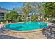 Community pool surrounded by lounge chairs at 1074 Kensington Park Ct # 101, Altamonte Springs, FL 32714