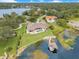 Expansive lakefront property with manicured lawn, pool, and private dock with boat lift, offering luxurious lakeside living at 10845 Bayshore Dr, Windermere, FL 34786