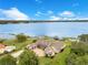 Aerial view showcasing the property's prime waterfront location, with private dock and boat lift on a serene lake at 10845 Bayshore Dr, Windermere, FL 34786