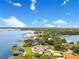 Panoramic aerial view of a waterfront property showcasing lush greenery, a serene lake, and neighboring residences at 10845 Bayshore Dr, Windermere, FL 34786