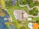 Overhead view of a luxury property with a large lot, pool, and boat dock with a covered boat lift on a beautiful lake at 10845 Bayshore Dr, Windermere, FL 34786