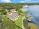 Stunning estate featuring a waterfront lot, lush landscaping, a private pool, and a boat dock with covered boat lift at 10845 Bayshore Dr, Windermere, FL 34786