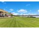 Lush lawn, covered patio, and dock create the perfect outdoor space at 10845 Bayshore Dr, Windermere, FL 34786