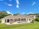 Expansive backyard with a covered patio, outdoor seating, and a refreshing pool, perfect for relaxation and entertainment at 10845 Bayshore Dr, Windermere, FL 34786