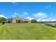 Expansive backyard with lush lawn and a private dock leading to the lake at 10845 Bayshore Dr, Windermere, FL 34786